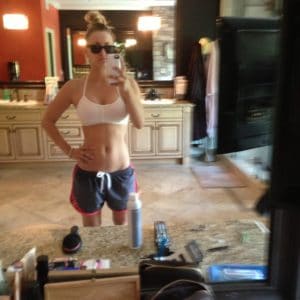 selfie of kaley cuoco showing off her fit body in sports bra and shorts