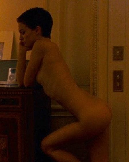 The sophisticated Natalie Portman in the nude standing by a desk