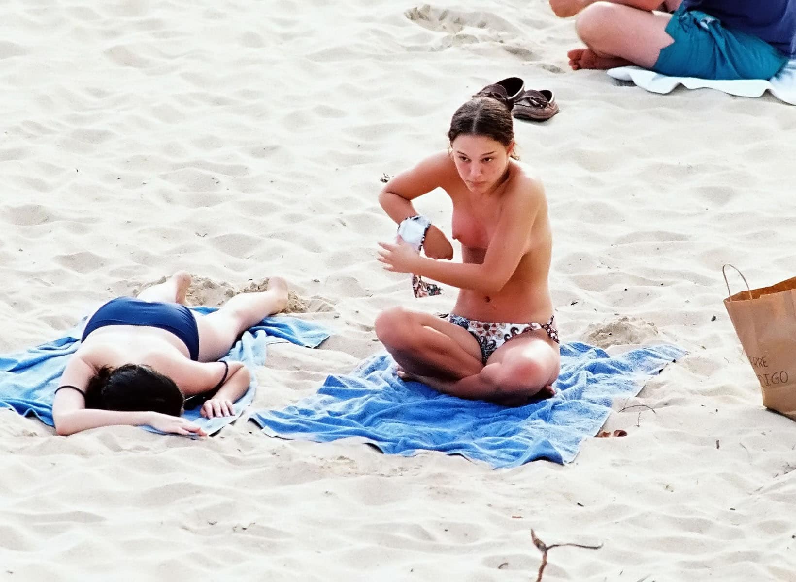 celeb Natalie Portman taking her top off at the beach