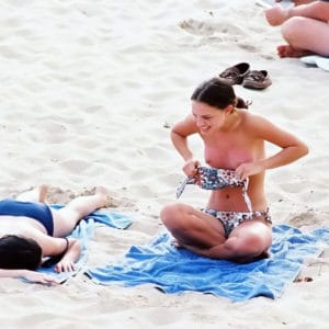 The famous Natalie Portman putting her top back on at the beach