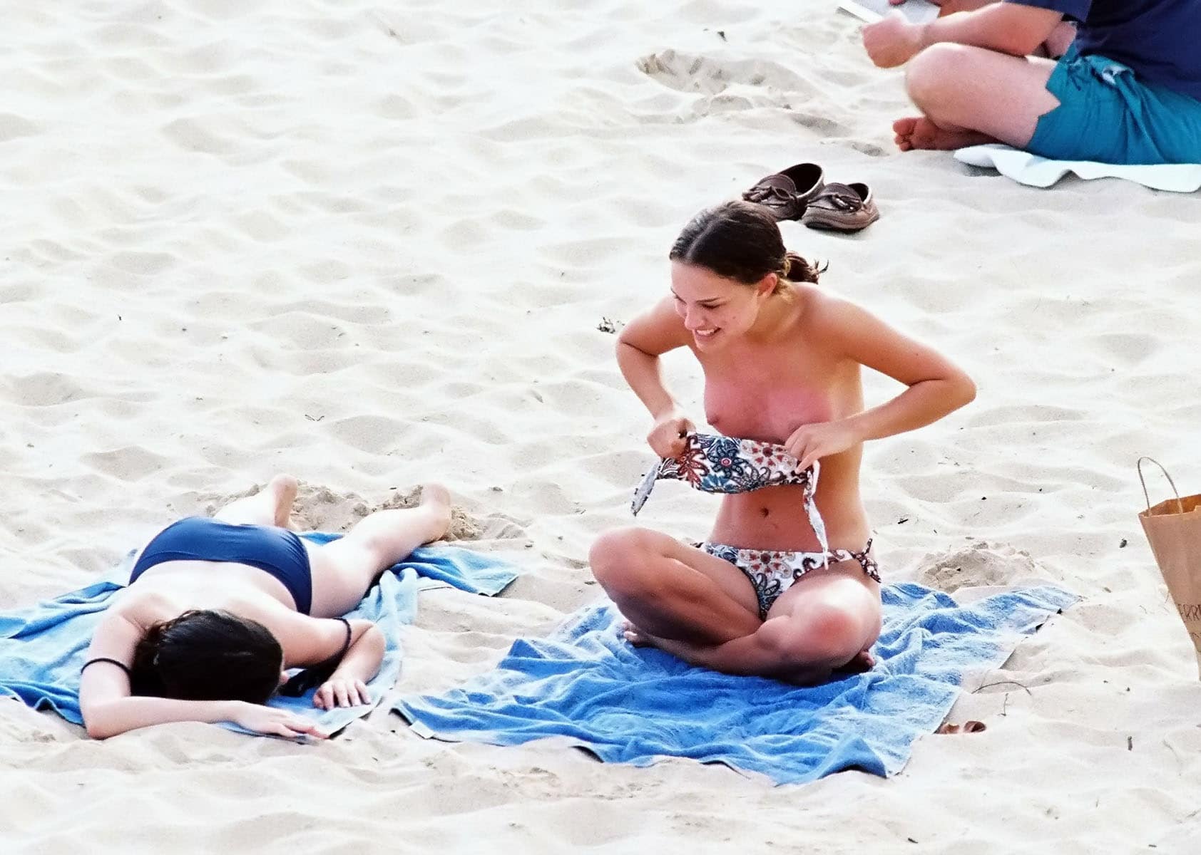 The famous Natalie Portman putting her top back on at the beach