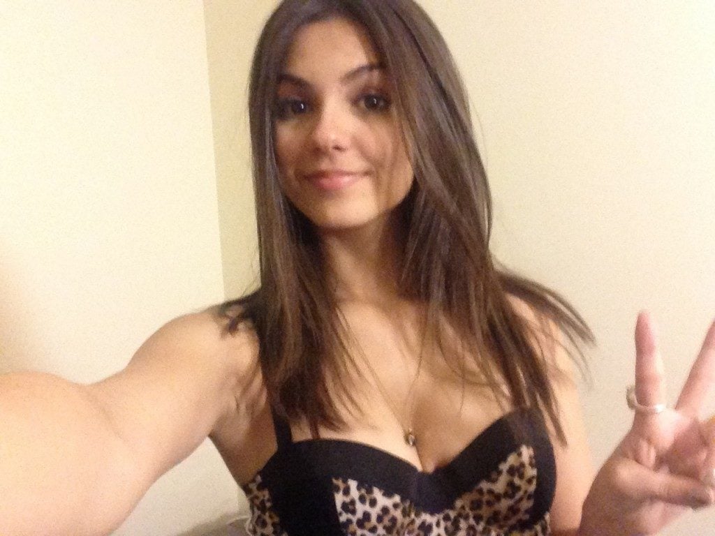 the celebrity Victoria Justice in black and leopard top showing some cleavage