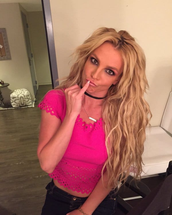 Britney Spears in hot pink shirt making a funny face