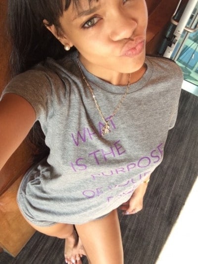 Rihanna taking a selfie wearing a gray t-shirt
