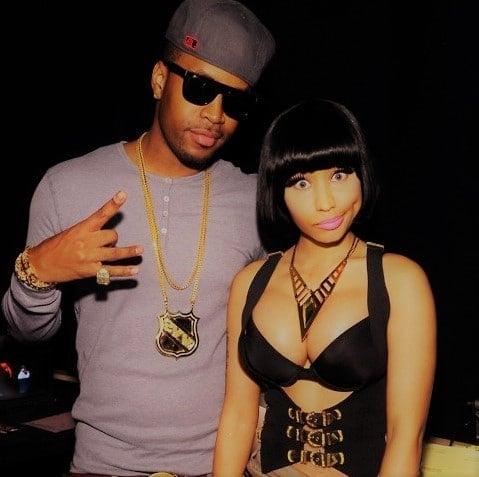 Safaree Samuels giving a peace sign to the camera and Nicki Minaj looking hot in sexy black outfit with bangs