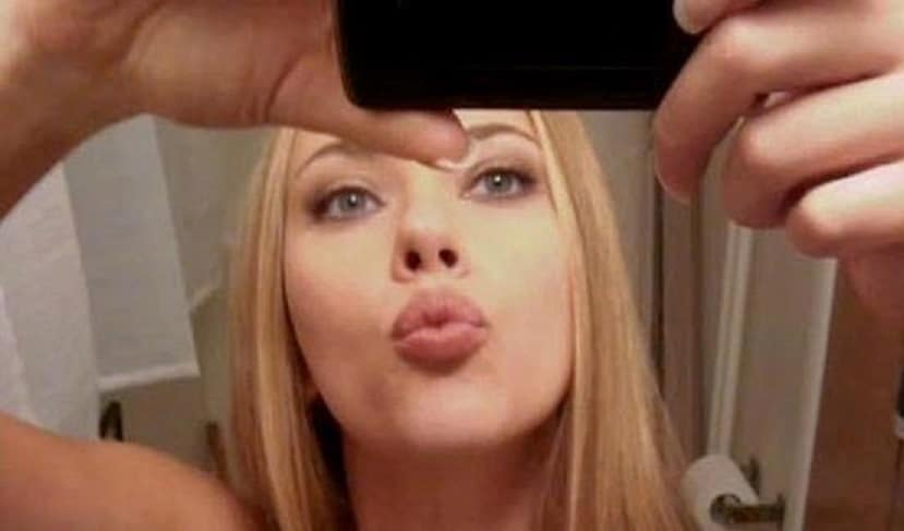 Scarlett Johansson taking a mirror selfie and making a kissy face