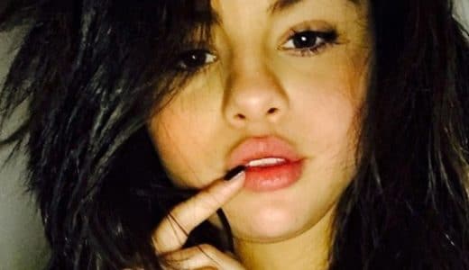 Selena Gomez selfie with finger on her lip looking hot