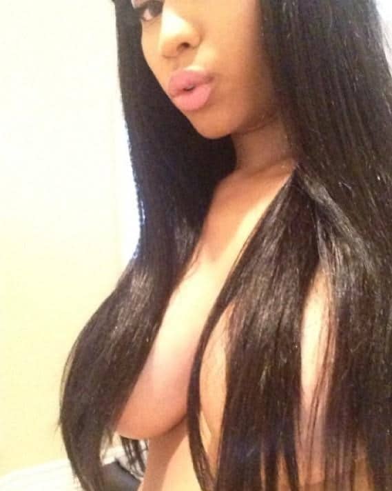 Selfie photo of Nicki Minaj covering her tits with her long hair