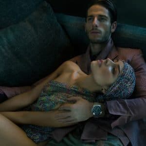Treats Magazine modeling photo of Olivia Culpo in head scarf with man holding her on couch looking up