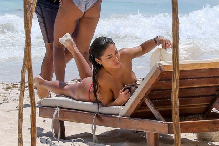Arianny Celeste laying down with no bikini top on