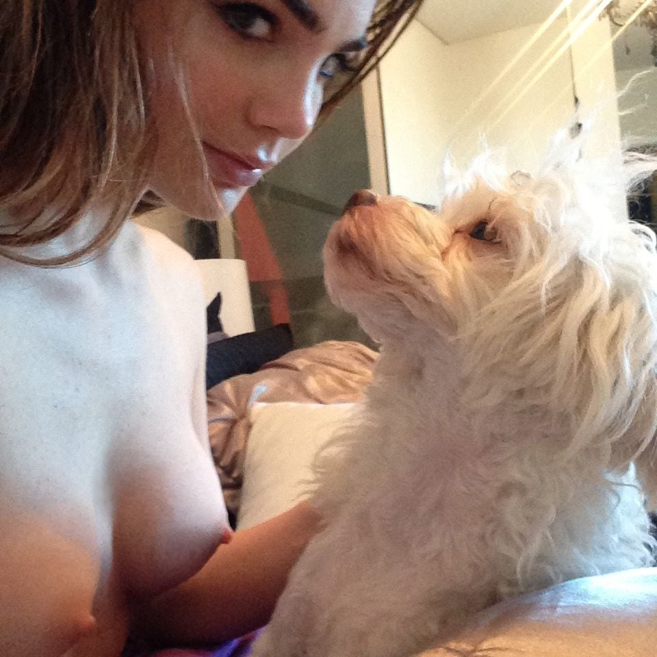 Jillian Murray taking a topless selfie with dog