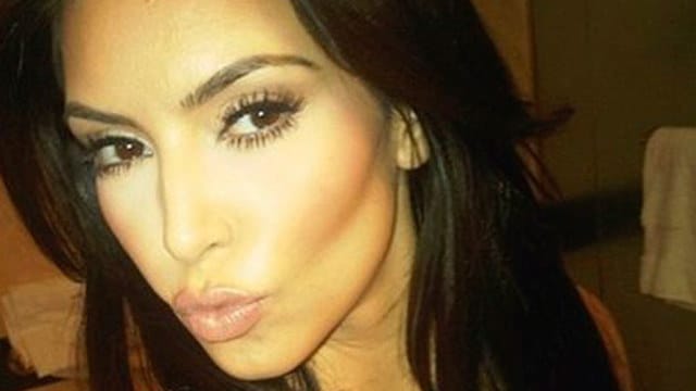 Kim Kardashian taking a selfie and making a duck face