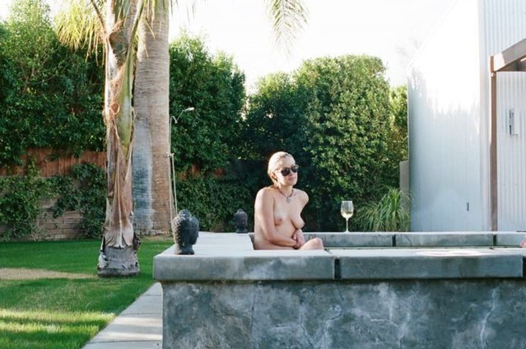 Kristanna Loken sitting in a hot tub topless