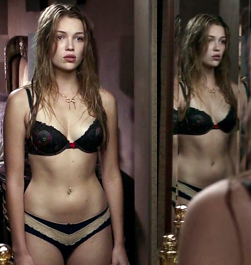 Lili Simmons in underwear standing by a mirror