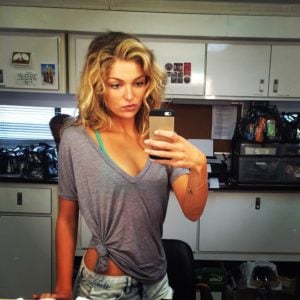 Lili Simmons taking a selife in her movie trailer in a sheer t-shirt