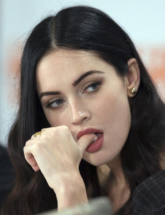 Megan Fox with finger in her mouth wearing red lipstick