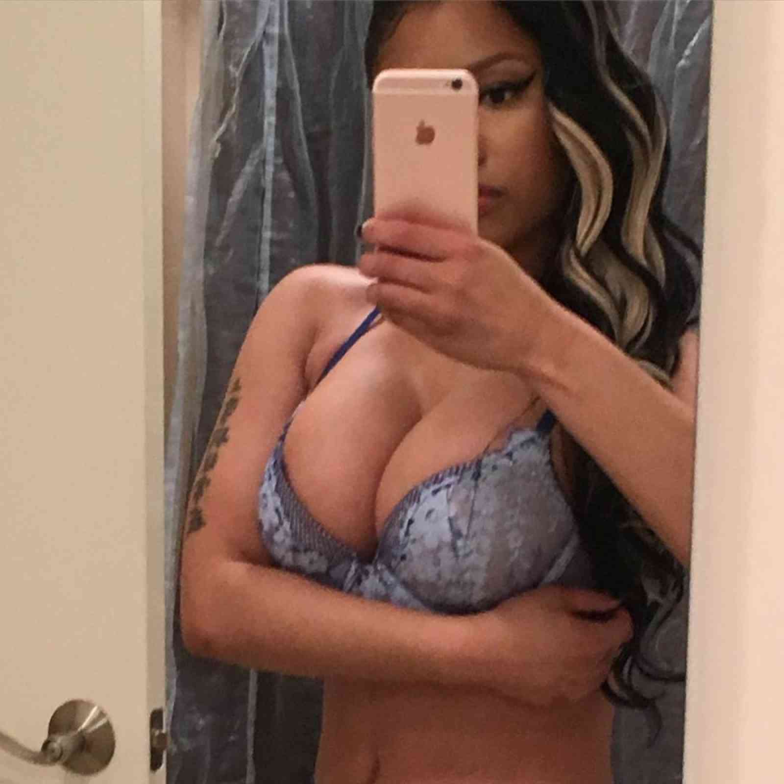Nicki Minaj taking a bathroom selfi in blue bra
