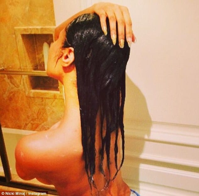 Nicki Minaj with her hand on her head topless