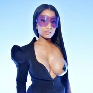 Nicki Minaj with her tit out during paris fashion week and wearing purple glasses