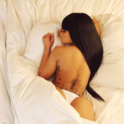 Blac Chyna laying in bed on her stomach
