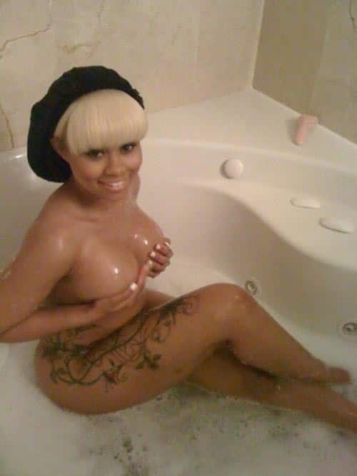 Blac Chyna sitting in bath tub holding her tits