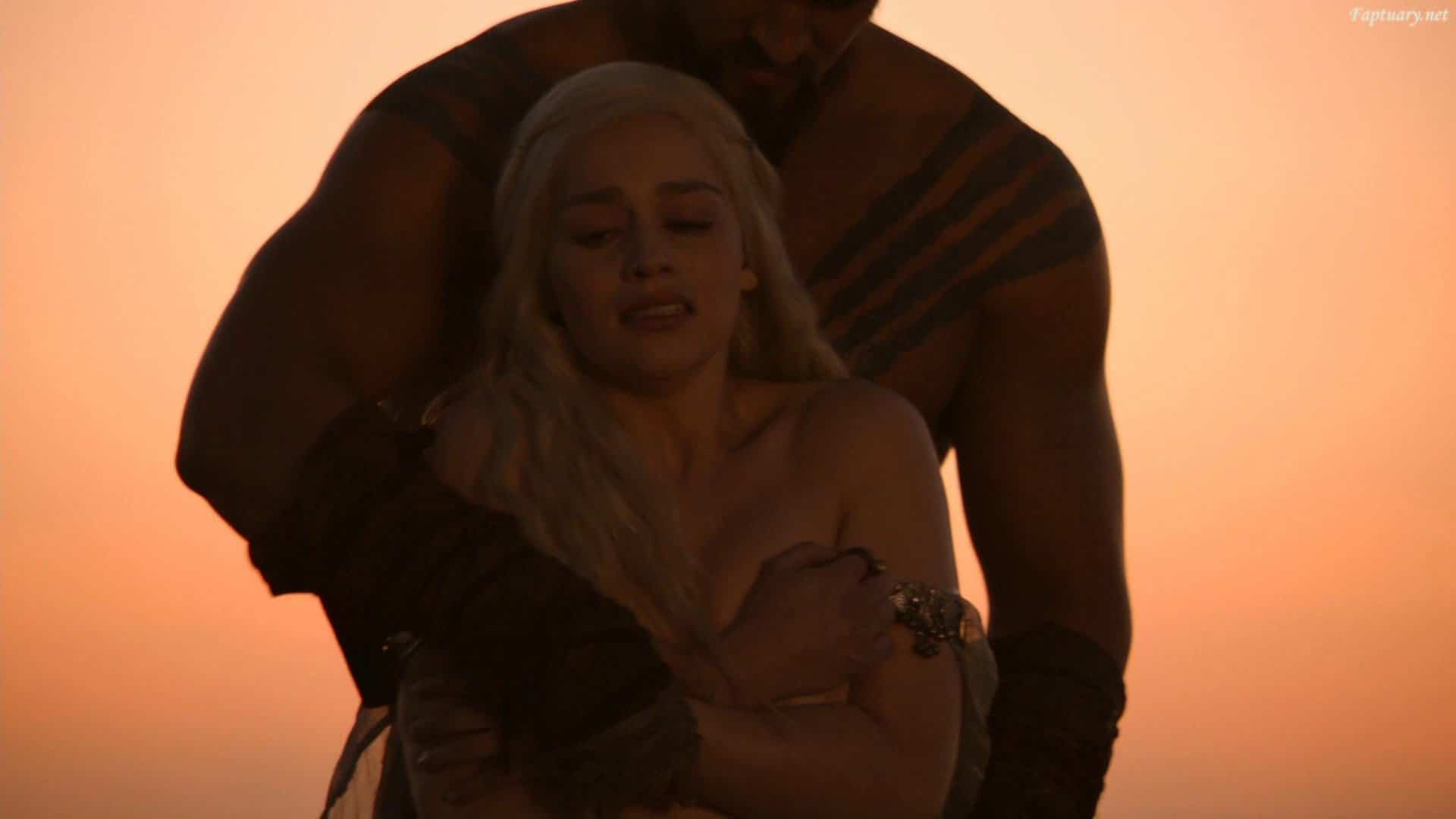 Emilia Clarke being restrained by a man