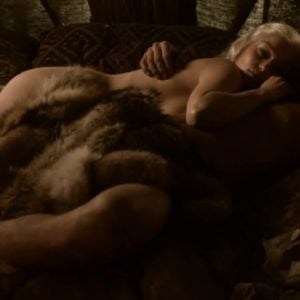 Emilia Clarke laying down next to man in the nude fur covering her pussy