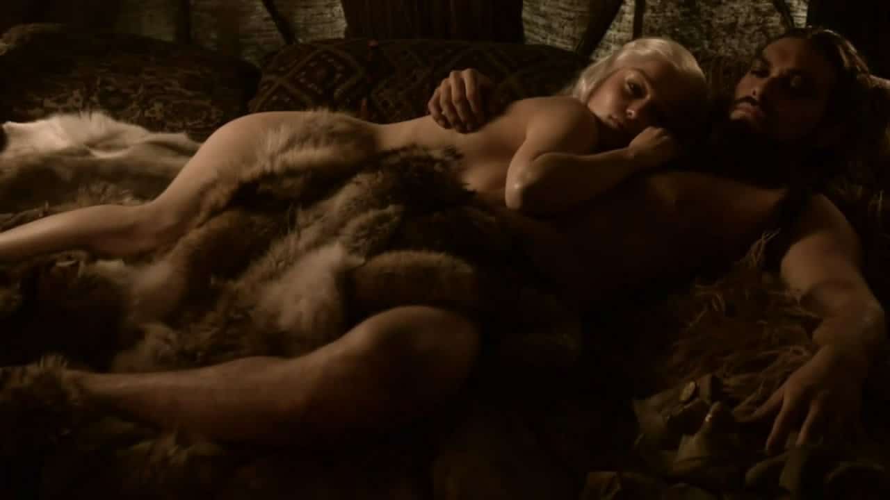 Emilia Clarke laying down next to man in the nude fur covering her pussy