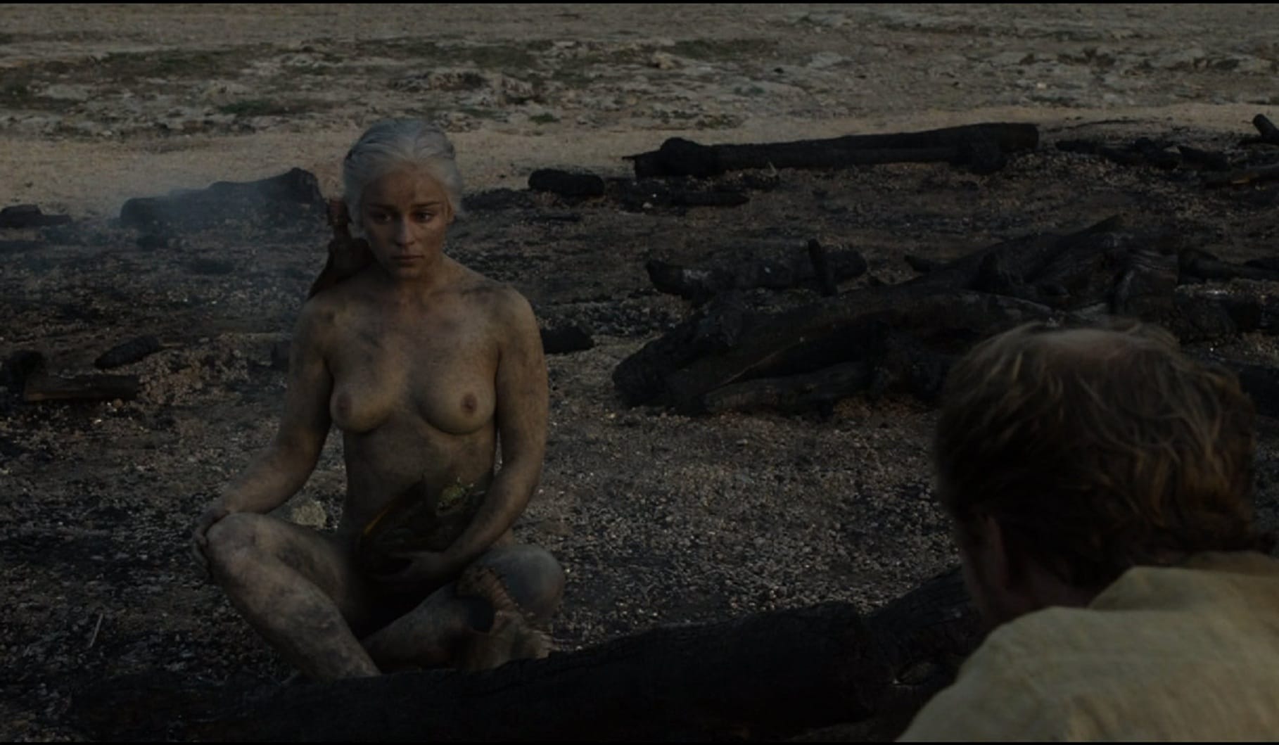 Emilia Clarke sitting down nude covered in ash