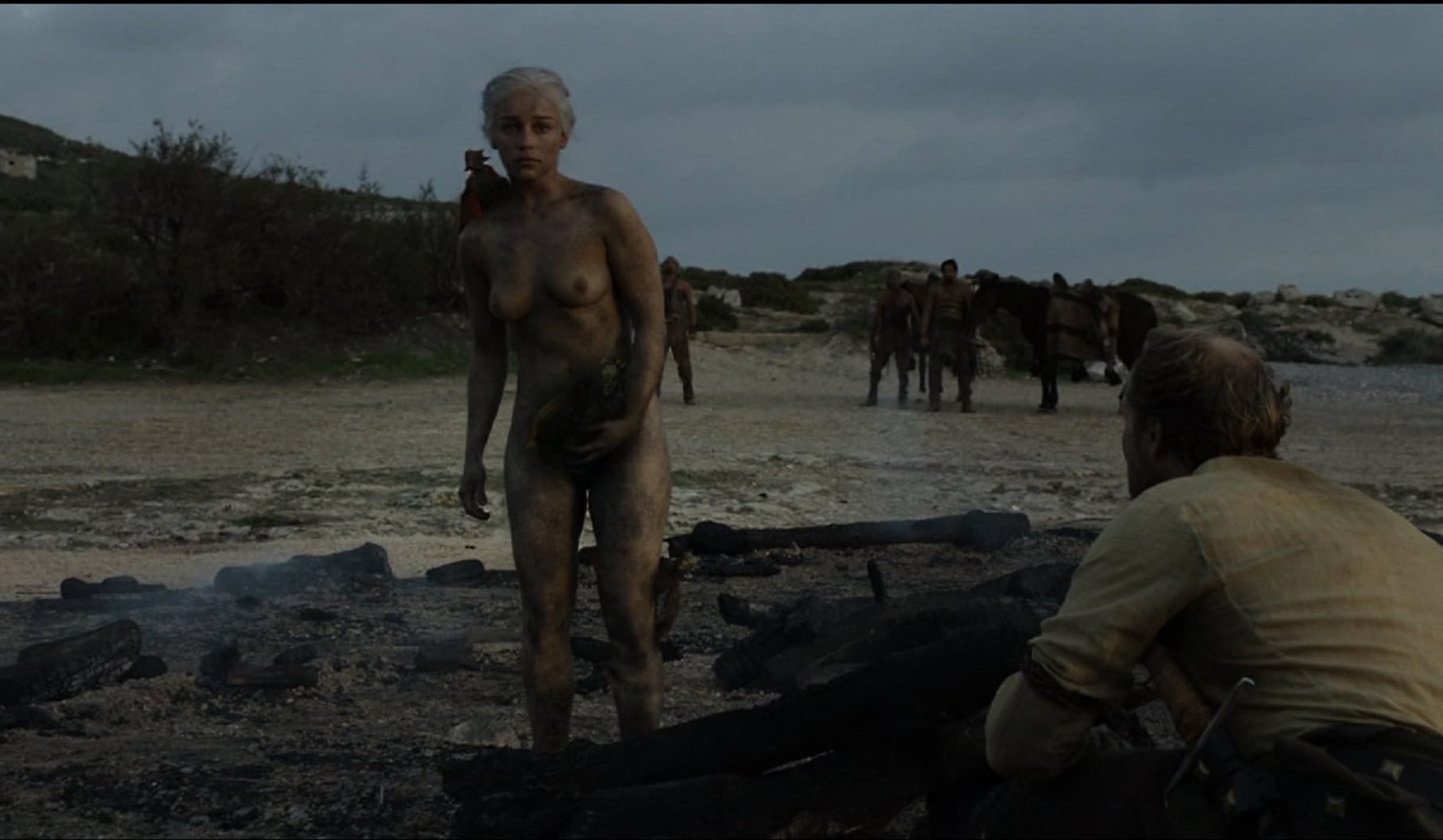 Emilia Clarke standing in the nude covered in ash