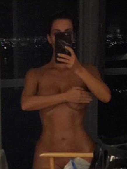 Kim Kardashian topless covering her big tits selfie
