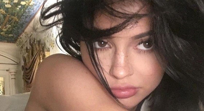 Kylie Jenner taking an up close selfie of her face with freckles visible