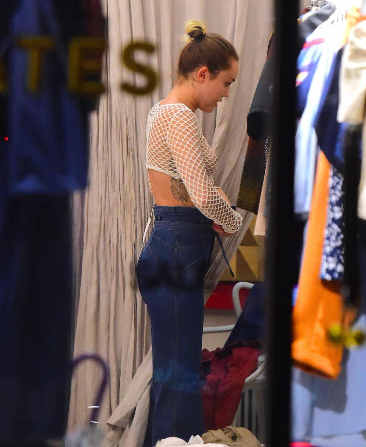Miley Cyrus changing her clothes in a white mesh top