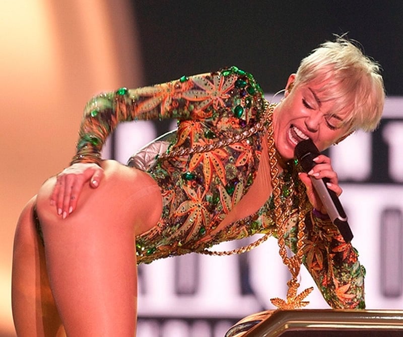 Miley Cyrus grabbing ass on stage mic in her hand