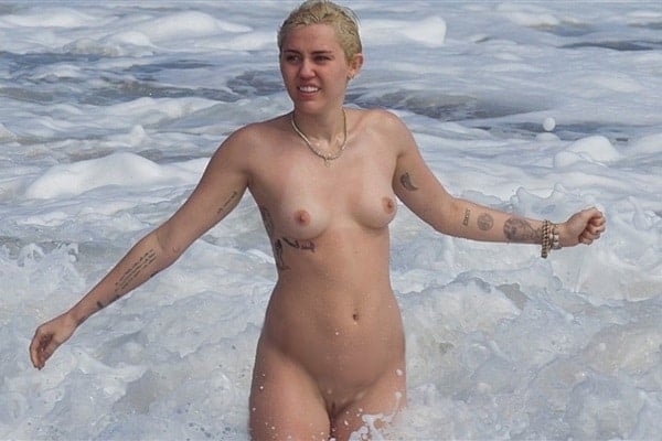 Miley Cyrus splashing in the ocean totally naked