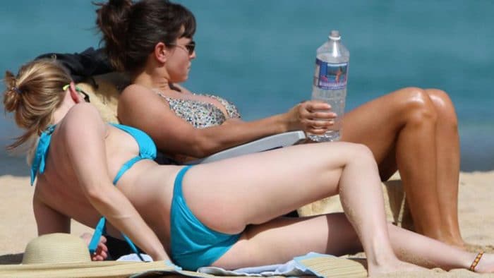 Picture of Scarlett Johansson in hawaii in a blue swimming suit laying out