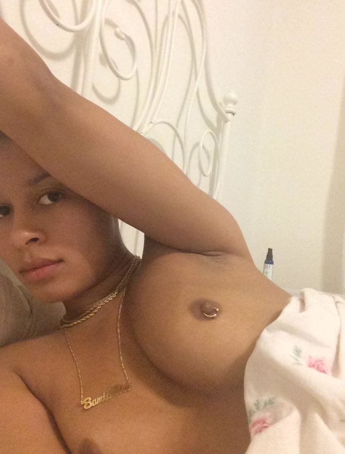 Sami Miro laying in bed topless nipple piercing visible