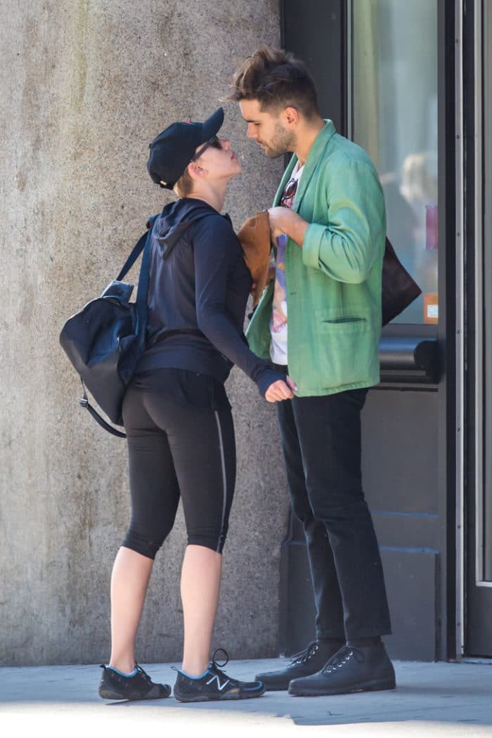 Scarlett Johansson in tight yoga pants next to her man