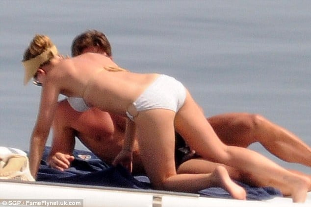 Scarlett Johansson on a boat in white bikini laying down