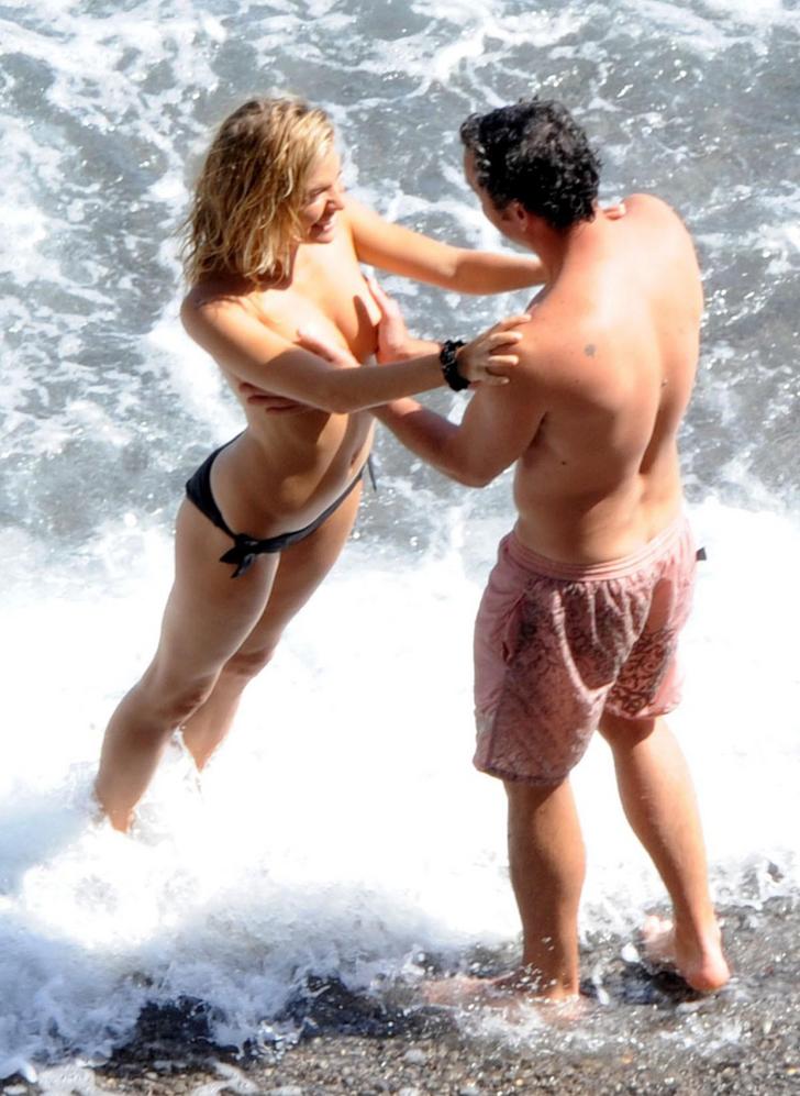 Sienna Miller at the beach topless standing in the ocean