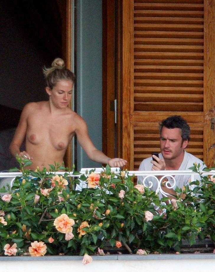 Sienna Miller on a balcony with no shirt on