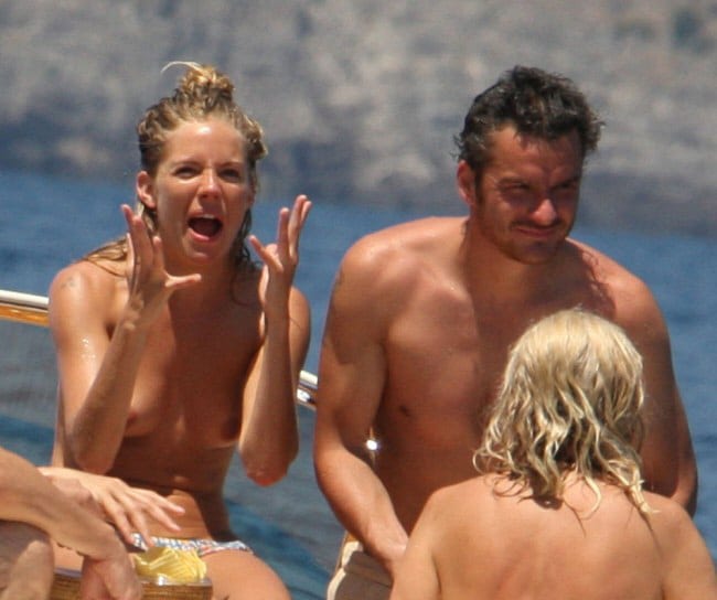 Sienna Miller screaming with no bikini top on at the beach with her bf