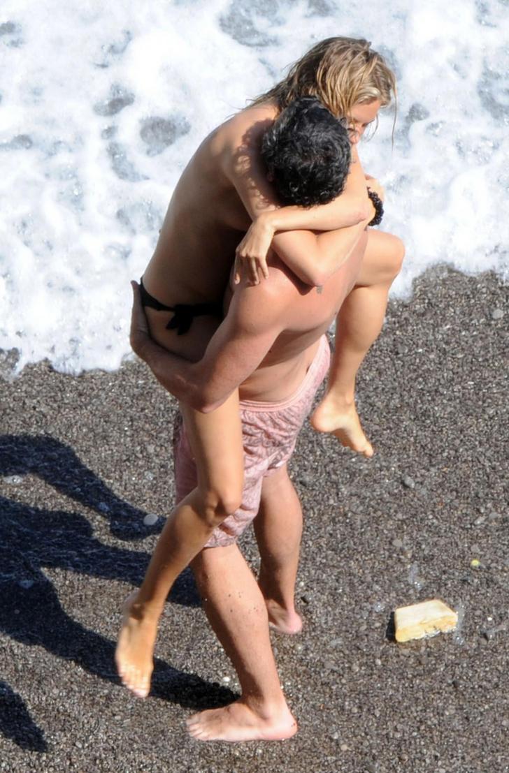 Sienna Miller topless getting picked up by a man at the beach