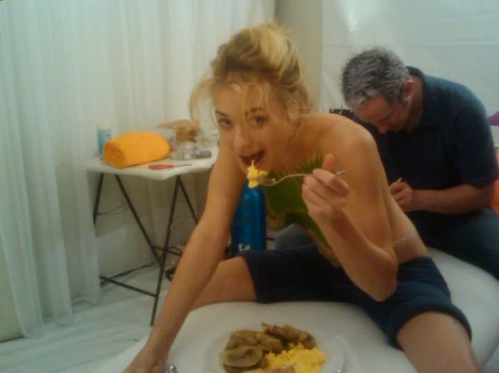 Yvonne Strahovski eating breakfast as she gets her back painted