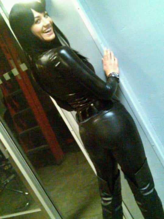 Yvonne Strahovski wearing a black wig and leather suit