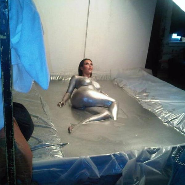 Kim Kardashian laying down in silver paint