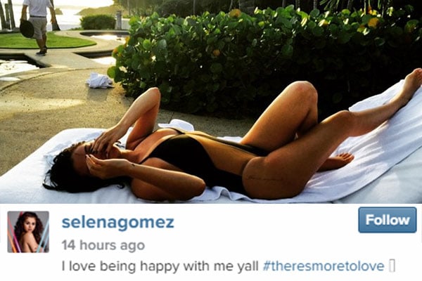 Selena Gomez laying with a one piece on